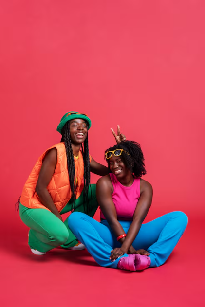 Two friends posing in colourful outfits
